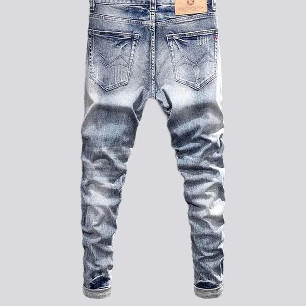 Slightly men's torn jeans